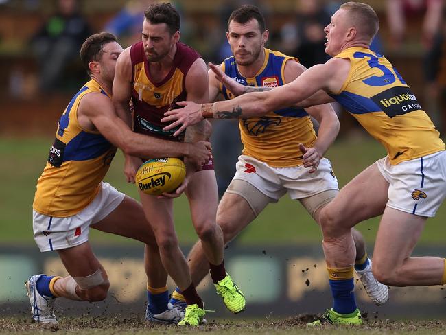 PERTH, AUSTRALIA - JUNE 19: Leigh Kitchin of the Lions gets tackled by Mark Hutchings of the Eagles during the WAFL Rd 11 match between the Subiaco Lions and West Coast Eagles at Leederville Oval on June 19, 2021 in Perth, Australia. (Photo by Paul Kane/Getty Images)