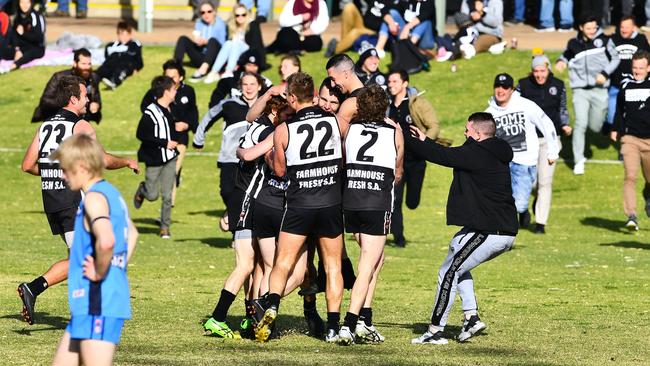 Daniel Nobes is mobbed by teammates and fans after kicking his 100th goal for Waikerie against Barmera-Monash in the Riverland Football League. Picture: Grant Schwartzkopff