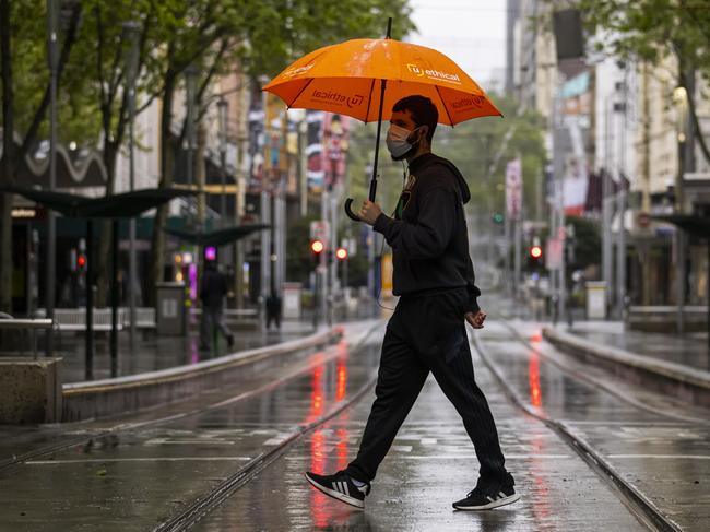 MELBOURNE, AUSTRALIA - OCTOBER 02: A lone person is seen crossing Bourke Street Mall on October 02, 2021 in Melbourne, Australia. Lockdown restrictions remain in place across metropolitan Melbourne and regional Victoria as new COVID-19 cases continue to emerge across the state. The state government is urging all Victorians to access the COVID-19 vaccine, with restrictions set to ease once 80 percent of people are fully vaccinated. (Photo by Daniel Pockett/Getty Images)