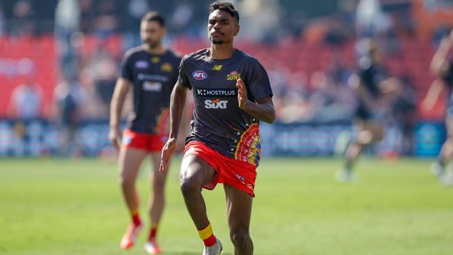 Lloyd Johnston of the Suns warms ahead of his AFL debut for the Gold Coast Suns. Picture: Russell Freeman/AFL Photos via Getty Images