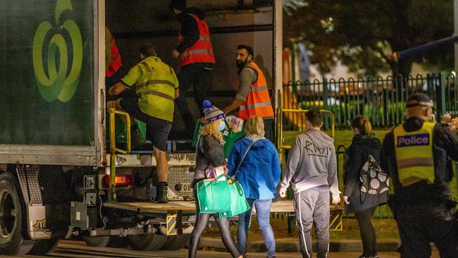 Food and groceries are delivered in a Woolworths truck to the locked down towers in Flemington. Picture: Tim Carrafa