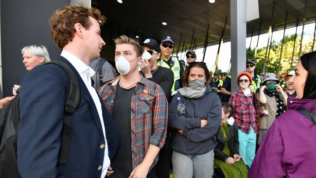 Protesters taunt a conference delegate. Picture: Jake Nowakowski