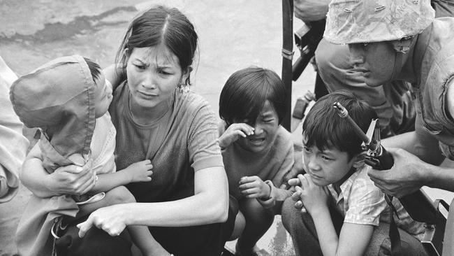 A South Vietnamese mother and her children are shown on the deck of an amphibious command ship plucked out of Saigon by US Marine helicopters on April 29, 1975. Picture: J.T. Wolkerstorfer/AP