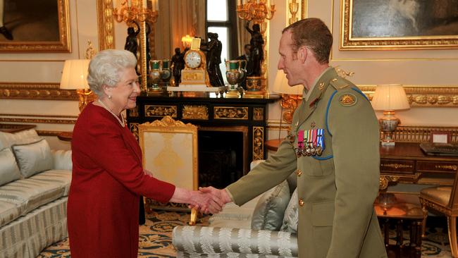 Queen Elizabeth II shakes hands with Australian Trooper Mark Donaldson VC during a private audience at Windsor Castle in 2009. Picture: Getty Images