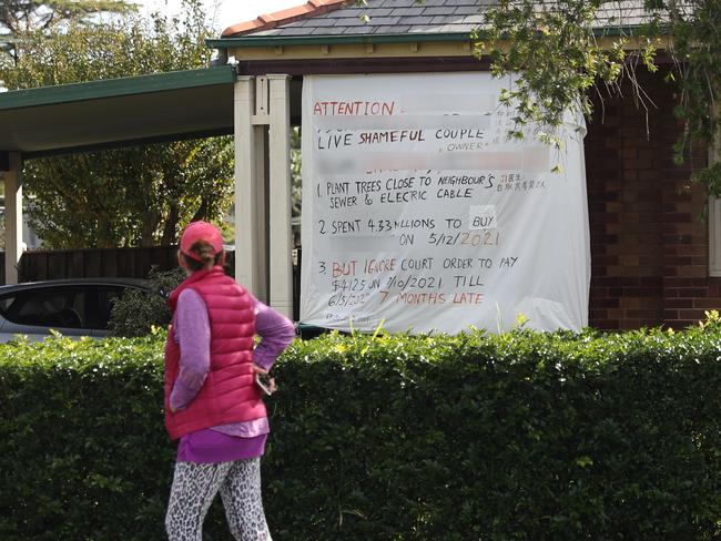 Hand drawn signs on bed sheets outside of Yuk Lo’s home. picture John Grainger