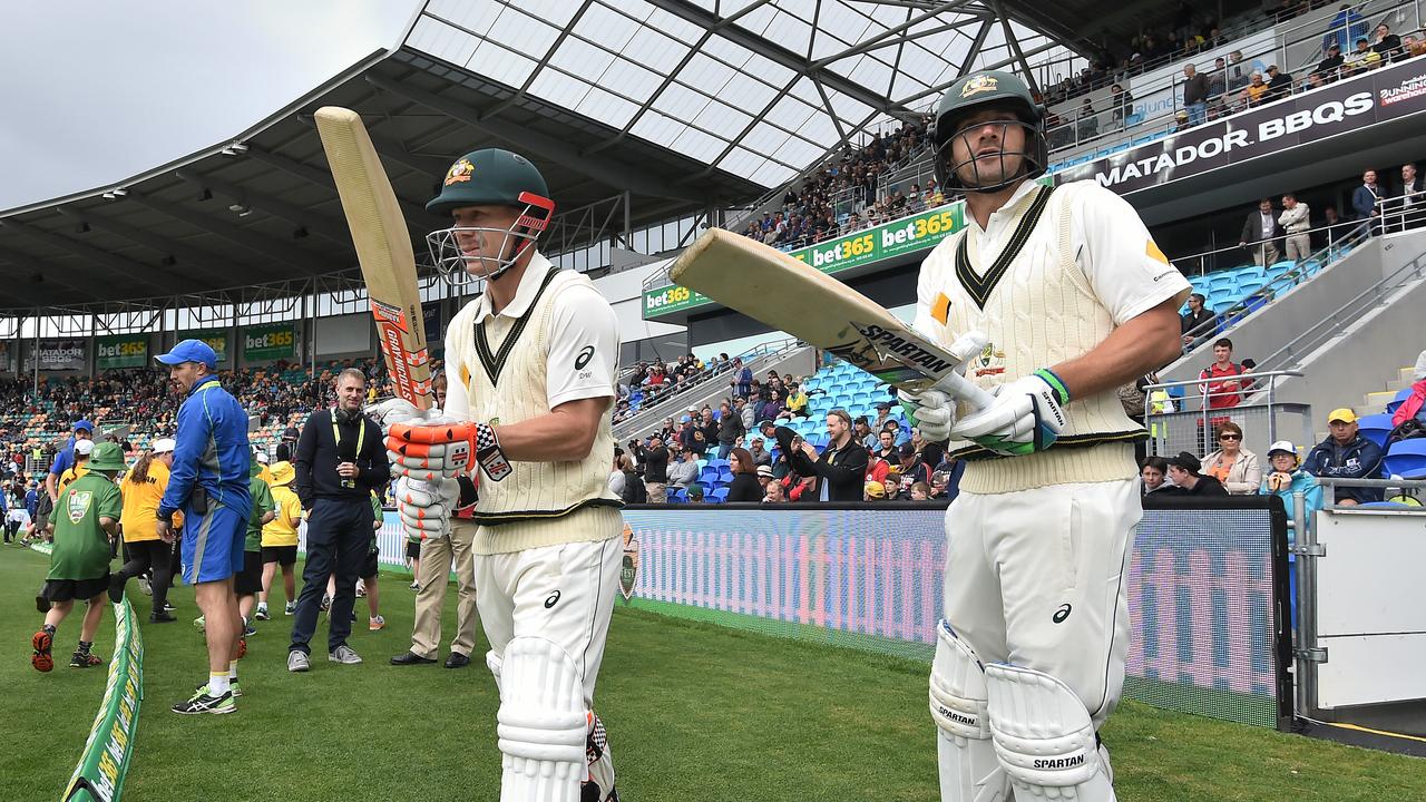 Australian batsmen David Warner (left) and Joe Burns take to the field for play on day one of the 2nd Test match between Australia and South Africa at Bellerive Oval in Hobart, Saturday, Nov. 12, 2016. (AAP Image/Dave Hunt) NO ARCHIVING, EDITORIAL USE ONLY, IMAGES TO BE USED FOR NEWS REPORTING PURPOSES ONLY, NO COMMERCIAL USE WHATSOEVER, NO USE IN BOOKS WITHOUT PRIOR WRITTEN CONSENT FROM AAP