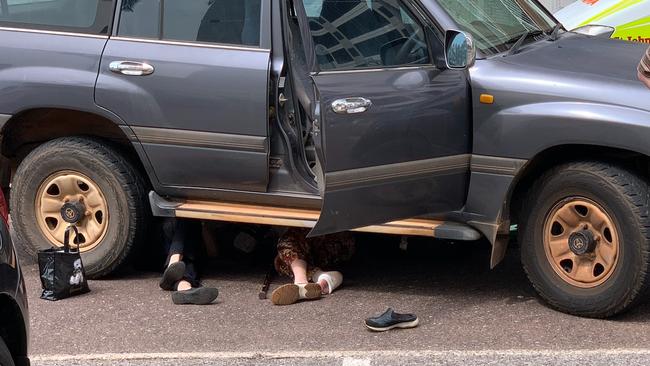 The pair were pinned under the car.