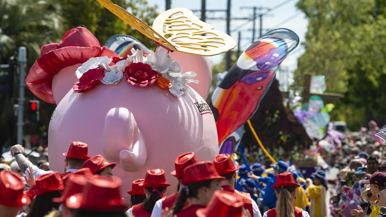 The Heritage Bank float is seen with crowds in Hume St during the Grand Central Floral Parade of Carnival of Flowers 2022, Saturday, September 17, 2022. Picture: Kevin Farmer