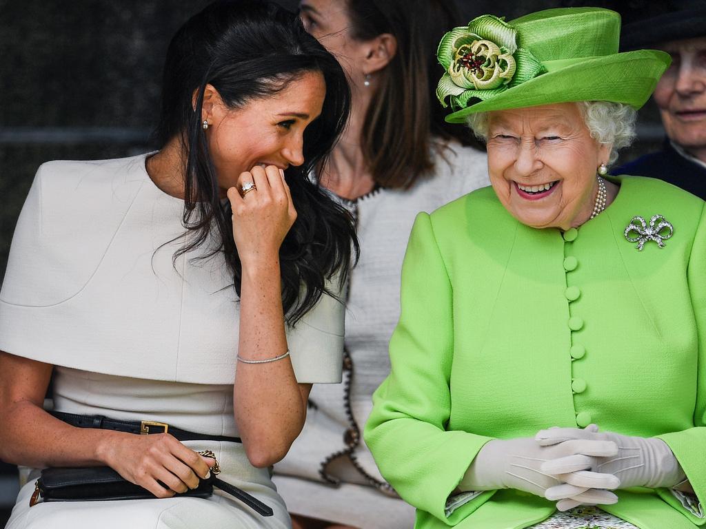 Queen Elizabeth II sits and laughs with Meghan, Duchess of Sussex. Picture: Jeff J Mitchell/Getty Images