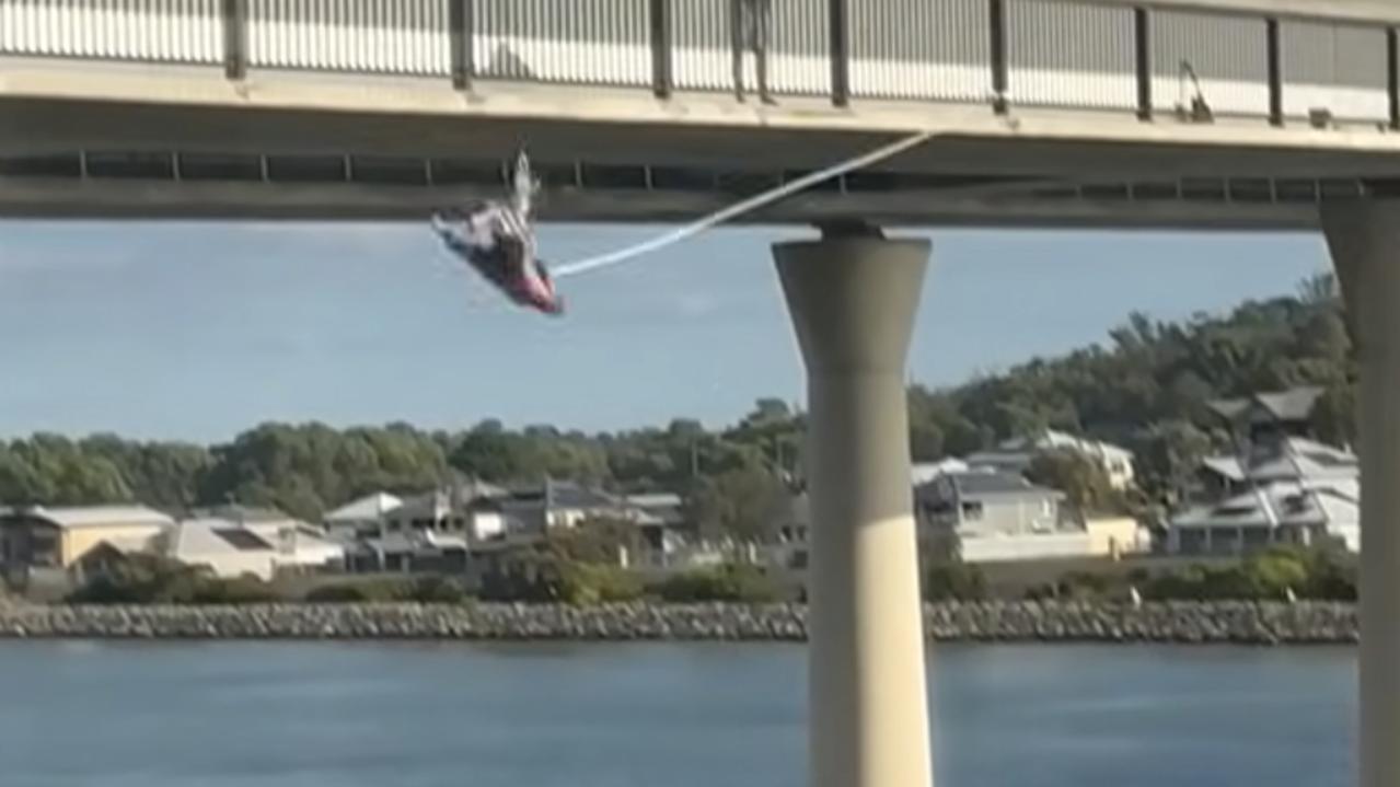 Wild footage as man bungees off bridge