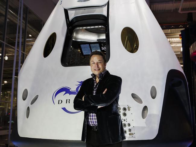 Elon Musk, chief executive officer of Space Exploration Technologies Corp. (SpaceX), stands for a photograph at the unveiling of the Manned Dragon V2 Space Taxi in Hawthorne, California, U.S., on Thursday, May 29, 2014. The Dragon V2 manned space taxi, an upgraded version of the unmanned spacecraft Dragon, will be capable of sending a mix of cargo and up to seven crew members to the International Space Station. Photographer: Patrick T. Fallon/Bloomberg *** Local Caption *** Elon Musk