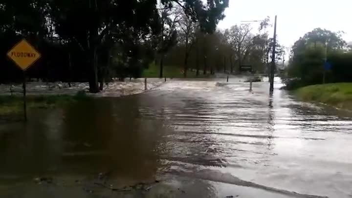 Onkaparinga River floods across the road at Oakbank