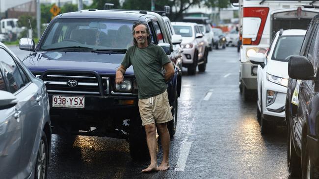 Traffic has queued at the bottom of the Kuranda Range Road on the Kennedy Highway, Smithfield, after the road was closed twice on Monday morning due to fallen trees and landslips. Mona Mona resident Toby Oui-Graham was stuck at the road closure, trying to get his children to school. Picture: Brendan Radke