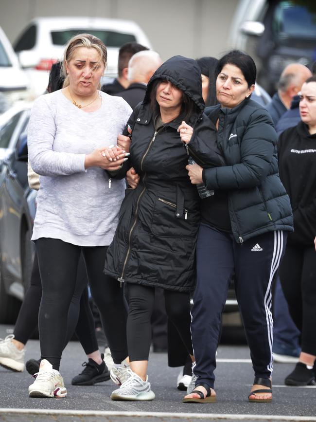 Devastated loved ones at the scene following the shooting. Picture: David Caird