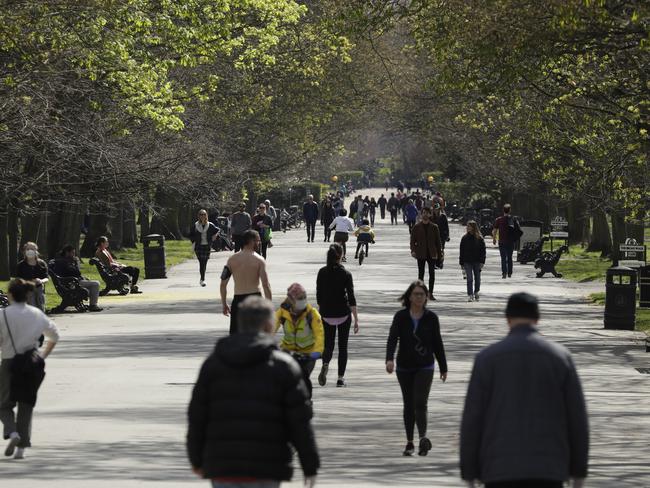 People spread out as they observe social distancing along the length of the Broad Walk in Regent’s Park, London. Picture: AP