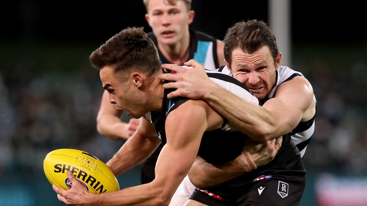 Karl Amon is tackled by Geelong’s Patrick Dangerfield in the 2021 AFL Second Qualifying Final match. Picture: James Elsby/AFL Photos via Getty Images