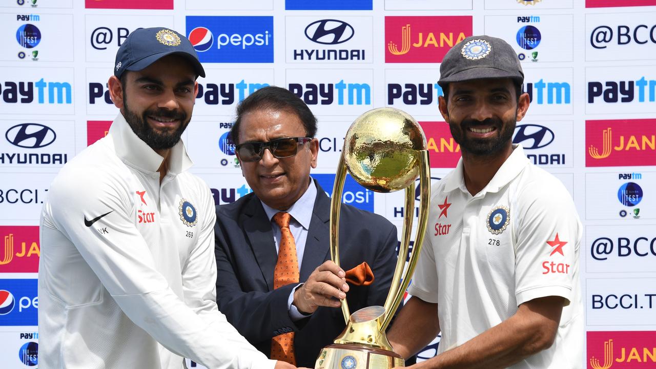 India's cricket captain Virat Kohli (L) and Ajinkya Rahane (R) receive the Border -Gavaskar trophy from Sunil Gavaskar after winning the series on home soil in 2017. Picture: AFP PHOTO