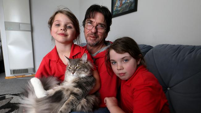 Duncan Storrar with his daughters Indica, 8 and Jakaylah-Rose, 6, at their home in Geelong, Victoria. Picture: David Geraghty