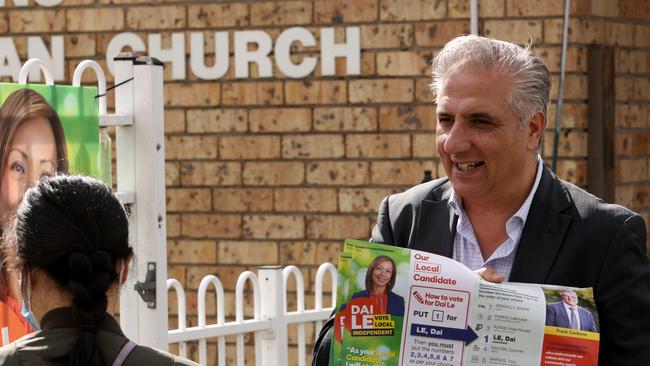 Mayor Frank Carbone handing out how to vote cards at pre polling at St Johns Park Anglican Church in Sydney's Cabramatta. Picture: NCA NewsWire / Damian Shaw