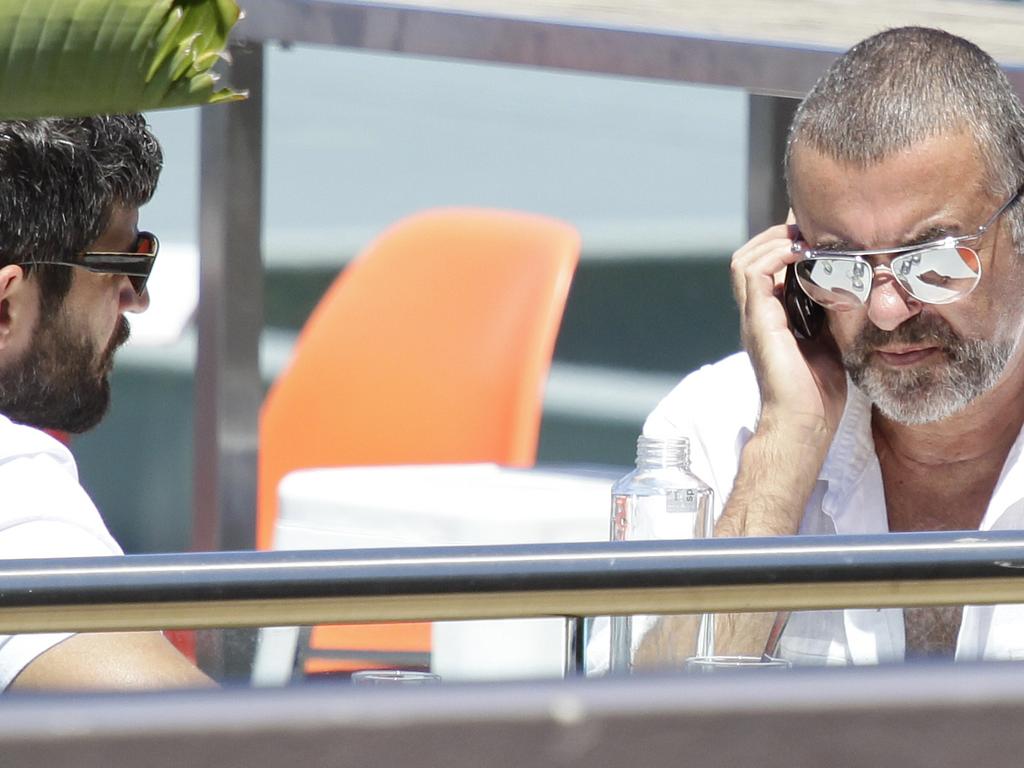 British singer George Michael (R) spotted with new boyfriend Fadi Fawaz at the Andrew (Boy) Charlton Pool cafe at Woolloomooloo in Sydney. Picture: News Corp