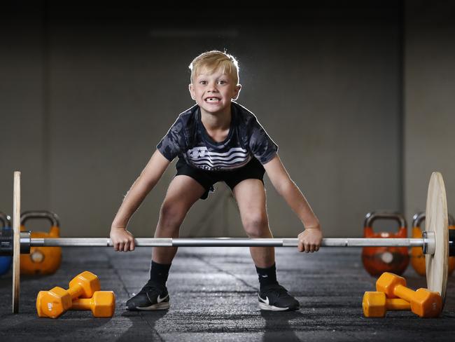 Kids are now joining crossfit with specific kids’ programs. Levi, 7, lifts above his weight. Picture: David Caird