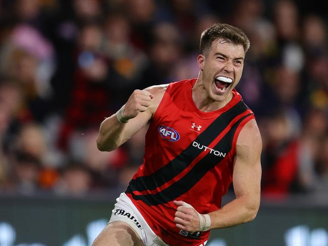 ADELAIDE, AUSTRALIA - APRIL 19: Zach Merrett of the Bombers celebrates a goal during the 2024 AFL Round 06 match between the Adelaide Crows and the Essendon Bombers at Adelaide Oval on April 19, 2024 in Adelaide, Australia. (Photo by Sarah Reed/AFL Photos via Getty Images)