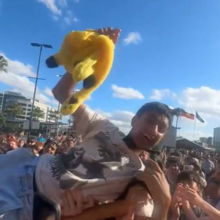 A fan crowd surfs.