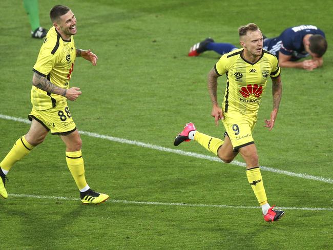 WELLINGTON, NEW ZEALAND - MARCH 15: David Ball of the Phoenix celebrates after scoring a goal while Gary Hooper looks on during the round 23 A-League match between Wellington Phoenix and Melbourne Victory at Westpac Stadium on March 15, 2020 in Wellington, New Zealand. (Photo by Hagen Hopkins/Getty Images)