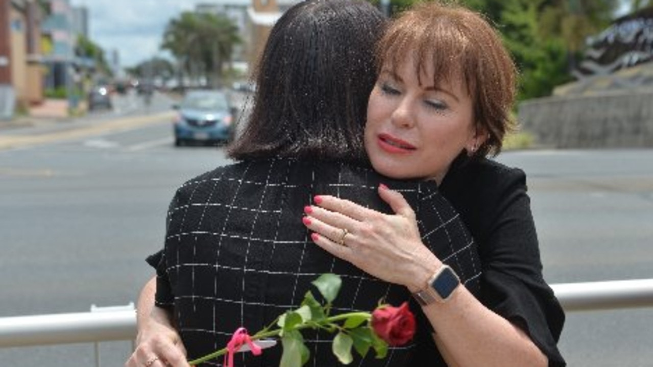 Broken Ballerina Foundation director Jules Thompson with a fellow victim of domestic violence at the Red Rose Rally in Mackay.