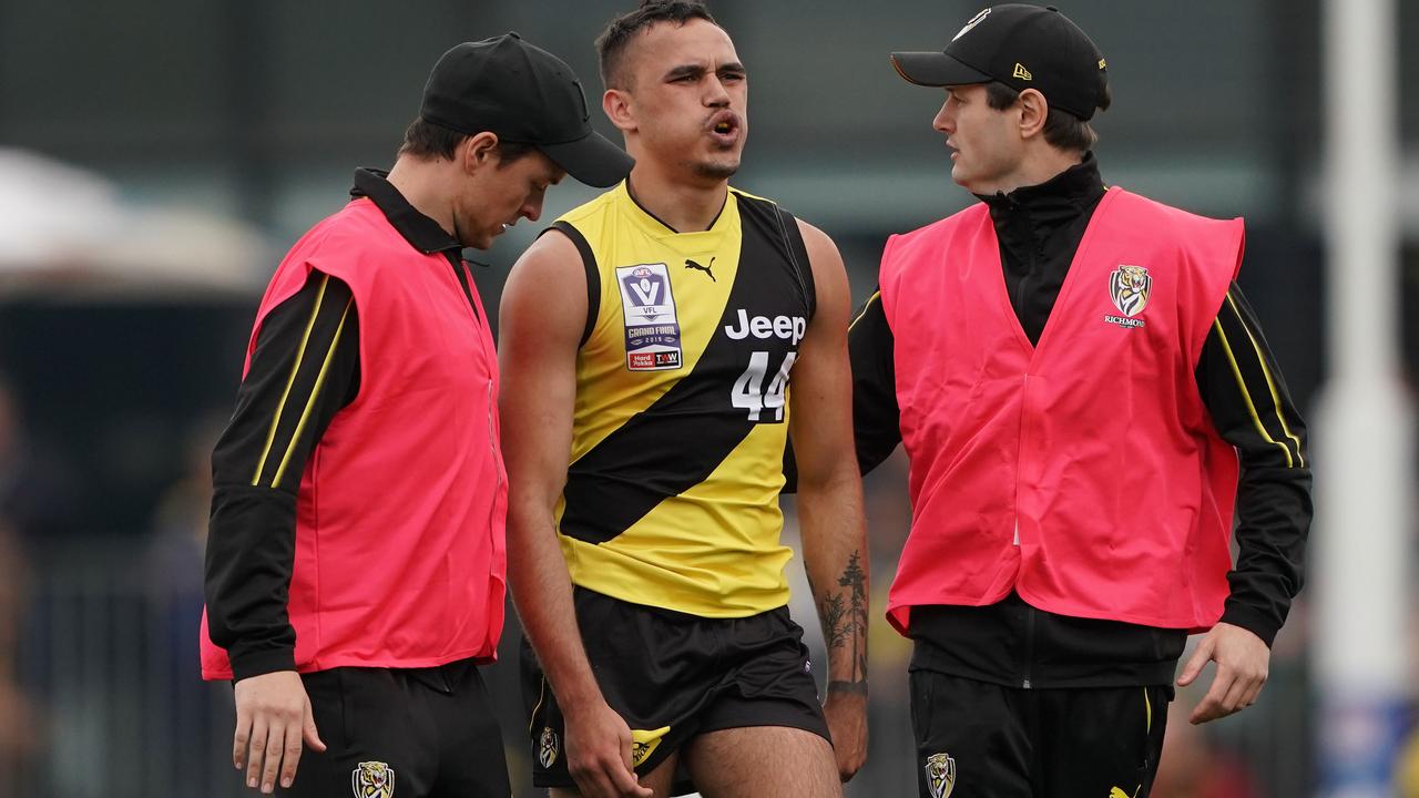 Sydney Stack leaves the field injured during the VFL Grand Final.