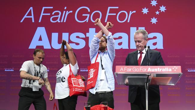 Anti-Adani protesters disrupt Bill Shorten’s address to Labor’s national conference. Pic: AAP