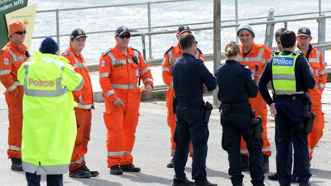 Police and SES attend a briefing before continuing the search. Picture: Andrew Henshaw