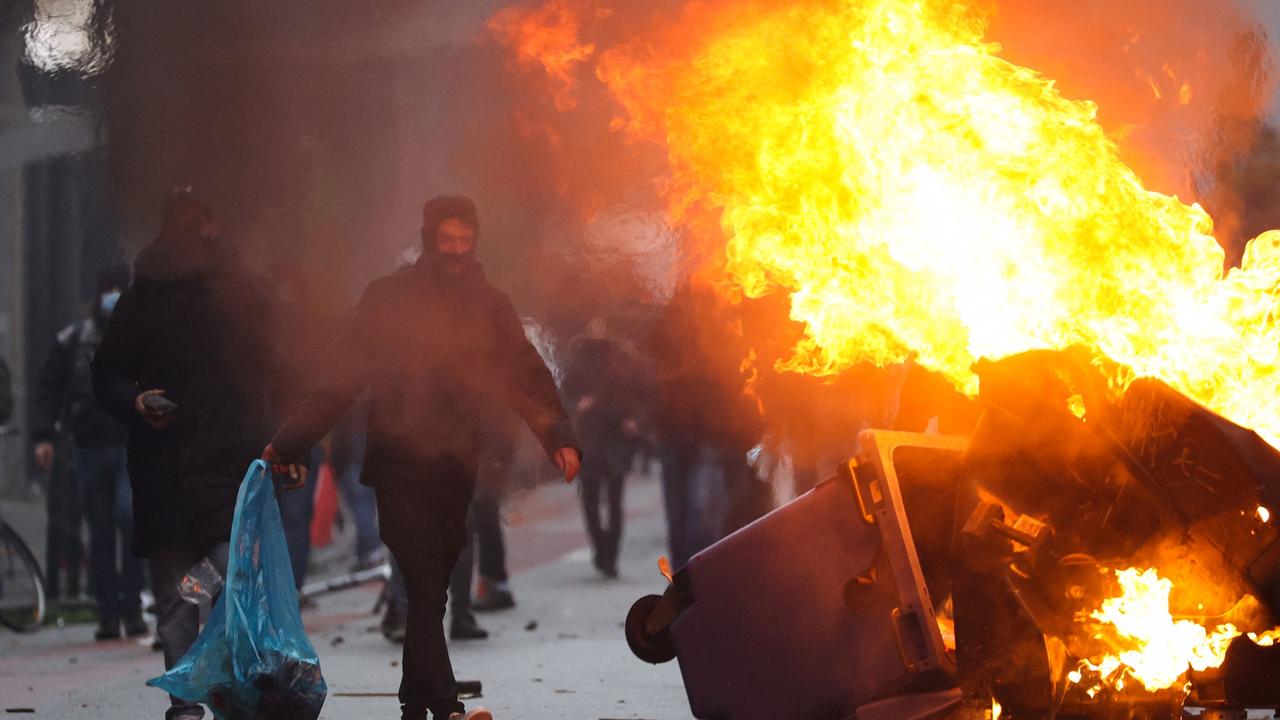 Rubbish burns as clashes erupt. Picture: Kenzo Tribouillard/AFP