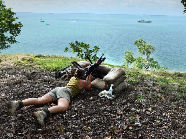 Bombing of Darwin Memorial Service. Gunner Zoe Monck takes aim on the machine gun during the re-enactment of the bombing raid. PICTURE: Patrina Malone