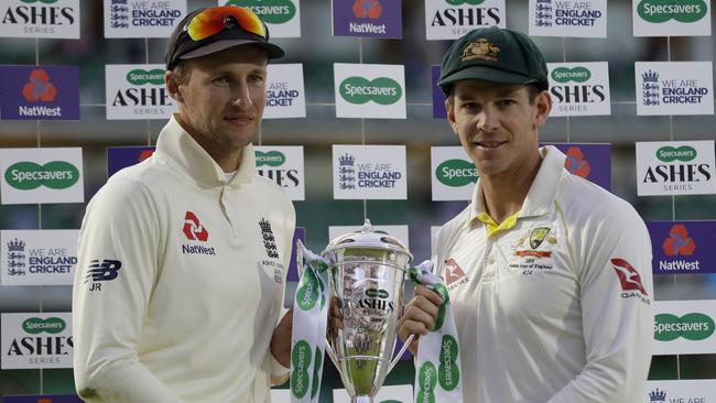 England's Joe Root, left, and Australia's Tim Paine hold the trophy during the presentation ceremony at The Oval.