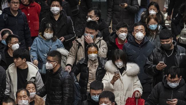 BEIJING, CHINA – JANUARY 23: Chinese passengers, almost all wearing protective masks, arrive to board trains at before the annual Spring Festival at a Beijing railway station on January 23, 2020 in Beijing, China. Picture: Getty