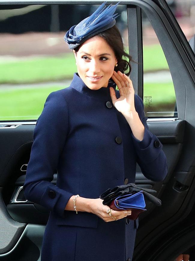 Meghan wore a coat dress unbuttoned from the waist down with a matching skirt to attend the wedding of Princess Eugenie to Jack Brooksbank on Saturday. Picture: AFP