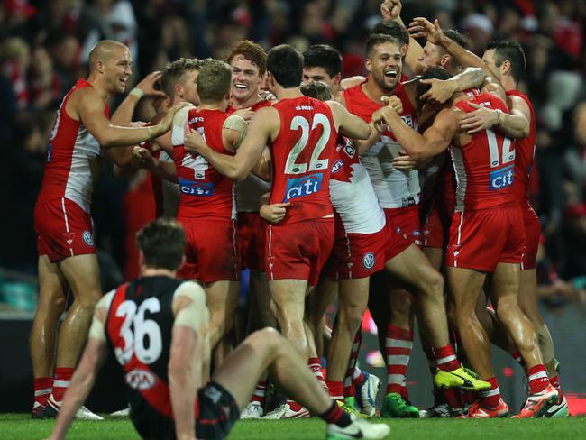 Gary Rohan of the Swans (centre) celebrates after kicking the winning goal against Essendon.