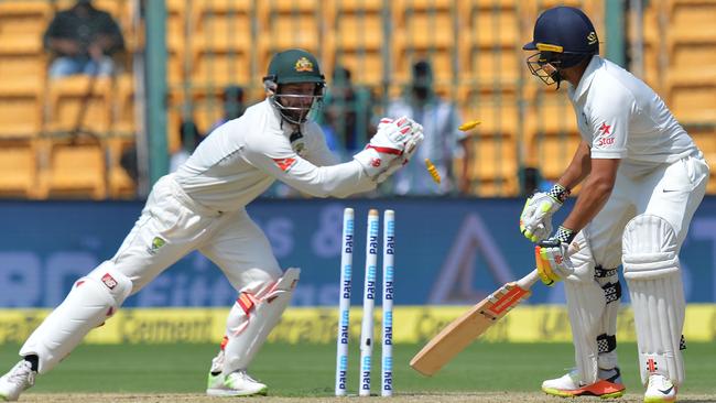 Matthew Wade (L) stumps India's Karun Nair during the first day of the second cricket Test match between India and Australia at The M. Chinnaswamy Stadium in Bangalore on March 4, 2017. GETTYOUT / AFP PHOTO / Manjunath KIRAN.