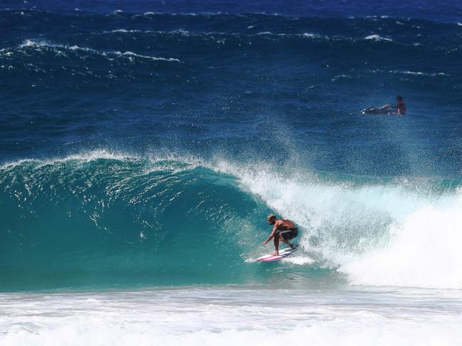 Mick Fanning rides a wave at Kirra during the large swell produced by Cyclone OMA. Photograph : Jason O'Brien