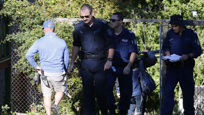 Police used chainsaws to cut down trees and shovels to dig underneath the Katoomba house this morning. Picture: David Swift.