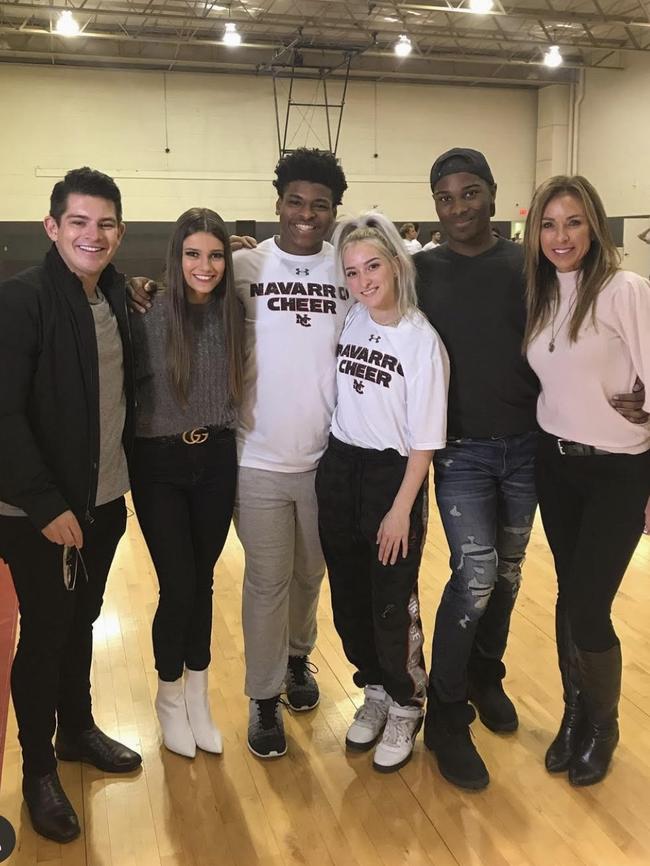 Tom Nicol (left) is pictured with stars of Netflix’s Cheer docuseries, including Jerry Harris (centre).