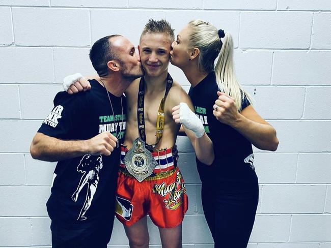 Dre (middle) with parents Brodie and Elise Stalder after being crowned the WMO Australian Champion. Picture: Contributed