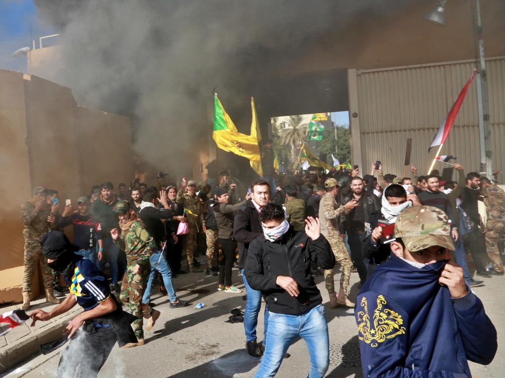 US soldiers fire tear gas towards protesters who broke into the US embassy compound, in Baghdad, Iraq. Picture: AP