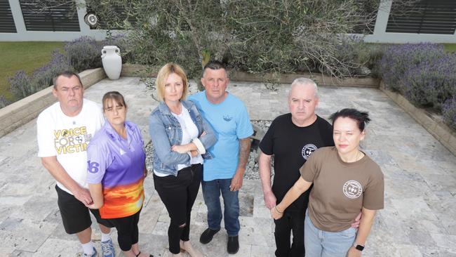 L to R, Graeme &amp; Annette Kimball, Kellie &amp; Troy Postle, Kent &amp; Kylie Payne, at a memorial space for Harry. The three families want a road safety roundtable with the premier. Picture: Steve Pohlner