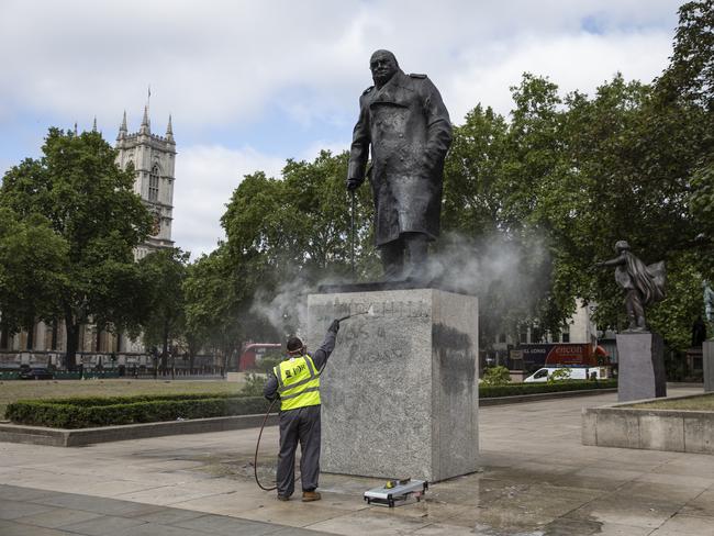 A worker cleans the Churchill statue in Parliament Square that was vandalised. Picture: Getty Images