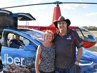 SCUBER SURPRISE: Gladstone couple Terry and Kym Purcell were the first paying customers to ride the scUber at Heron Island when it launched to the public yesterday. They are pictured next to the helicopter they took to the island and the official scUber Tesla driver Domenico Galluccio. Picture: Matt Harris