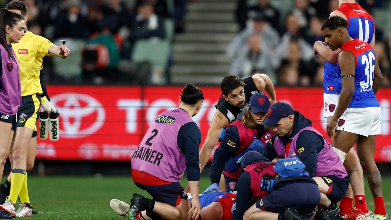 Teammates and Josh Daicos check on Brayshaw. Picture: Michael Willson/AFL Photos via Getty Images