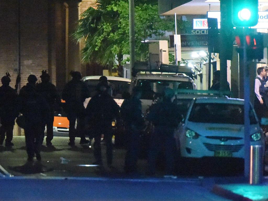 Armed police walk back following the end of the Sydney siege. Picture: Saeed Khan (AFP)