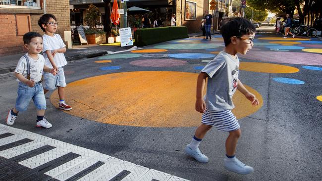 Harrison, Jackson and Xavier de Vera crossing Canterbury St in Yarraville where speed bumps have been put in place where intersections are covered in coloured dots. Picture: David Geraghty